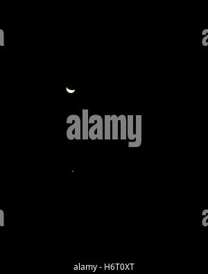 La luna a mani basse in un cielo pieno di stelle Foto Stock