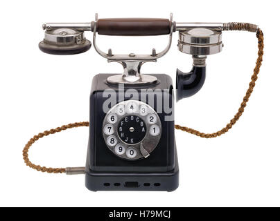 Oggetti isolati: un antico telefono nero, molto vecchio e invecchiato, isolato su sfondo bianco Foto Stock