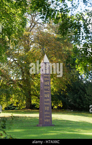 Om e Sanscrito sulla pace Obelisco a Waterperry giardini in autunno, Wheatley, Oxfordshire. Regno Unito Foto Stock