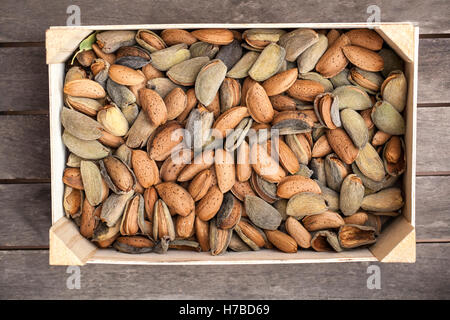 Scatola di legno di mandorle in loro gusci Foto Stock