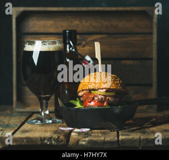 Hamburger di manzo con pancetta croccante, verdure e birra Foto Stock