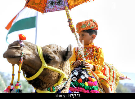 Molti adulti e bambini assiste al tradizionale decorazione cammello concorrenza al camel mela in Pushkar, Rajasthan, India. Foto Stock