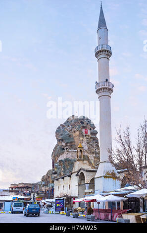 Il bianco snello minareto e il castello medievale scavata nella roccia naturale formazione Foto Stock
