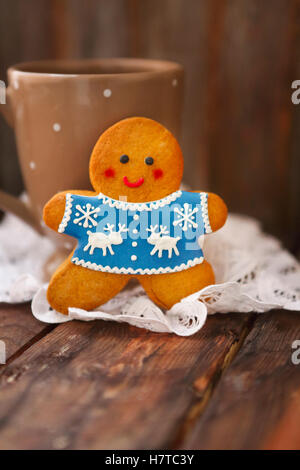 Natale sorridente gingerbread uomini su sfondo di legno. Foto Stock