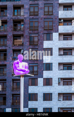 Uomo illuminato scultura su un palo di fronte ad un edificio visto dalla cascata di Yerevan, Armenia, Medio Oriente e Asia Foto Stock