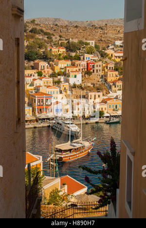 Guardando verso il basso sul porto di yialos su symi grecia che mostra le barche ormeggiate in porto Foto Stock