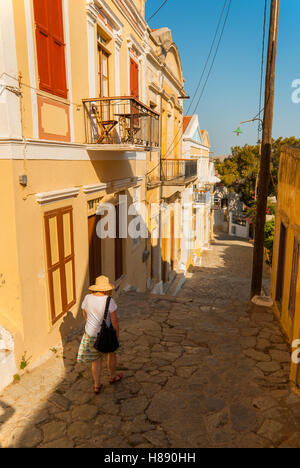 Donna che cammina verso il basso la Kalistrata, su Symi grecia, Foto Stock