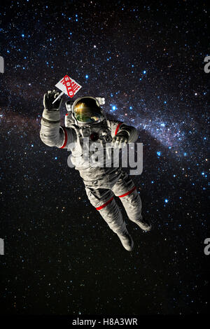 Astronauta nello spazio tenendo in vendita segno Foto Stock