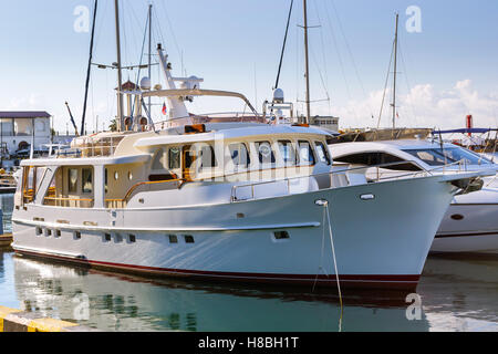 Yacht di lusso e barche private ormeggiate al molo a Sochi Seaport. In fondo è il calcestruzzo promenade e il mar Nero. Porta la Russia Foto Stock