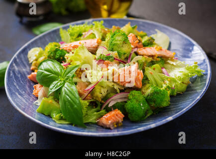 Insalata di pesce stufato di salmone, broccoli, lattuga e condimento. Menu di pesce. Menu dietetici. Frutti di mare - salmone. Foto Stock