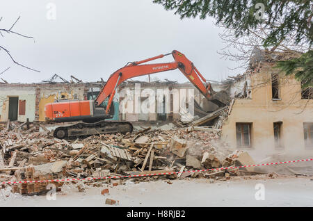 Digger demolizione di case per la ricostruzione Foto Stock