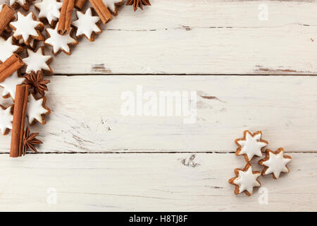 Vacanze di Natale sfondo con cannella quills, anice stellato e a forma di stella di cannella biscotti frollini su legno rustico Foto Stock