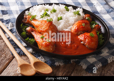 Piatto tailandese: il pollo con la salsa di peperoncino Sriracha e riso vicino sul tavolo orizzontale. Foto Stock
