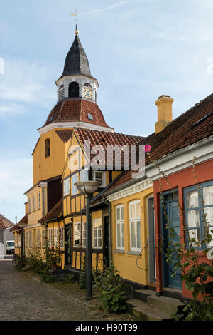 Il vecchio campanile della chiesa di San Nicolas e case colorate nella città di Faaborg, Danimarca Foto Stock