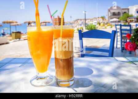 Occhiali con succo d'arancia e caffè greco Frappé Foto Stock