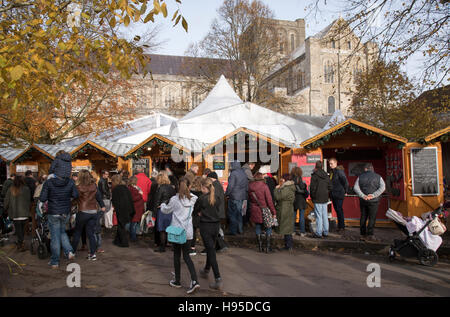 Visitatori presso l annuale mercatino di Natale nel parco della Cattedrale di Winchester Hampshire England Regno Unito Foto Stock