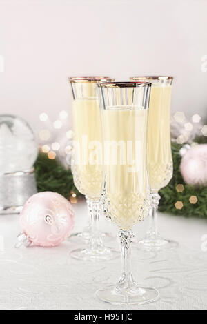 Zabaione scanalato in bicchieri di cristallo con decorazioni di Natale in background. Profondità di campo con il fuoco selettivo sul vetro in primo piano. Foto Stock