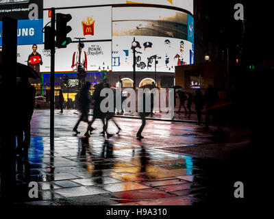 La pioggia riflette Piccadilly Circus luci nel centro di Londra Foto Stock