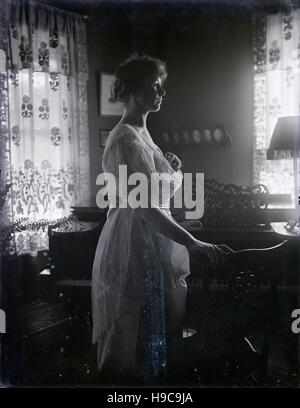 Antique c1900 fotografia, donna di profilo nella parte anteriore del pianoforte. Fonte: originale negativo fotografico. Foto Stock