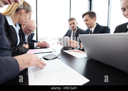 Un gruppo di persone di affari di lavoro con documenti e computer Foto Stock