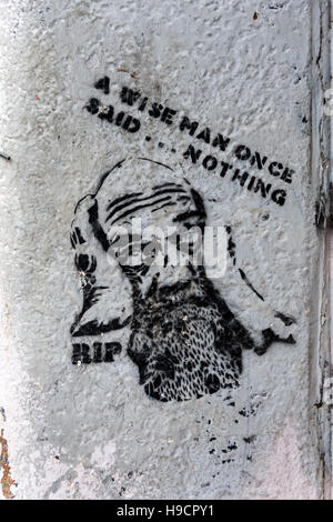 Piccola parete murale di un uomo faccia barbuta, con un preventivo - " Un uomo saggio una volta che detto... niente', Northern Quarter, Manchester, Regno Unito Foto Stock