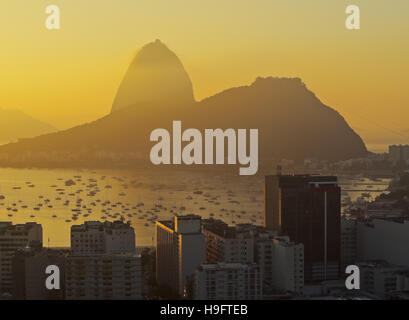 Il Brasile, la città di Rio de Janeiro, vista sul quartiere di Botafogo verso la montagna di Sugarloaf a sunrise. Foto Stock