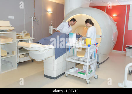 Radiologo preparazione paziente di sesso femminile per MRI scan in ospedale Foto Stock