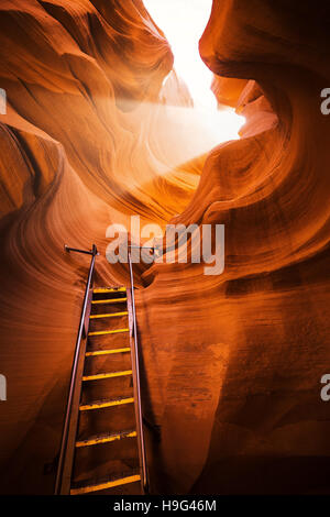 Incredibili formazioni di pietra arenaria con una scala che conduce verso la magia di un fascio di luce nella famosa Antelope Canyon, Arizona, Stati Uniti d'America Foto Stock