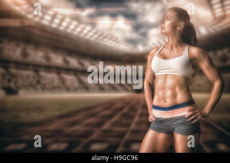 Immagine composita di atleta femminile in posa con le mani sul hip Foto Stock