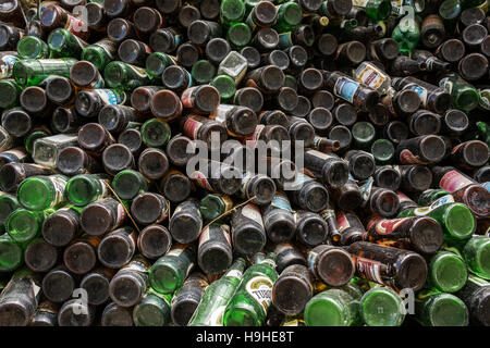 Cumulo di bottiglie di birra memorizzata all'aperto per la vendita per il riciclaggio. Foto Stock