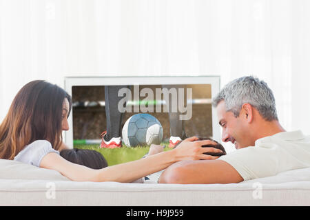 Immagine composita del giocatore di football dando dei calci a sfera Foto Stock