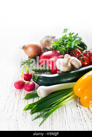 Fresche verdure miste raccolta su bianco sullo sfondo di legno Foto Stock