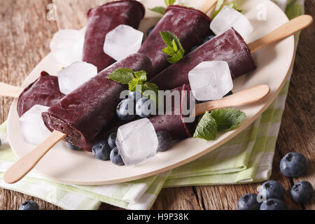 Mirtillo frutta per lecca-lecca di ghiaccio close up su una piastra sul tavolo orizzontale. Foto Stock