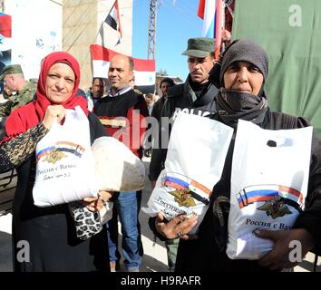 Damasco, Siria. 24 Novembre, 2016. Le persone ricevono aiuti russi in Damasco, Siria, nov. 24, 2016. La Russia ha ripetutamente inviato soccorsi alla guerra-stanco siriani attraverso il paese dilaniato dalla guerra. © Ammar Safarjalani/Xinhua/Alamy Live News Foto Stock