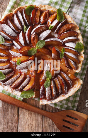 Pane appena sfornato fette di torta di prugne vicino sul tavolo. vista verticale da sopra Foto Stock