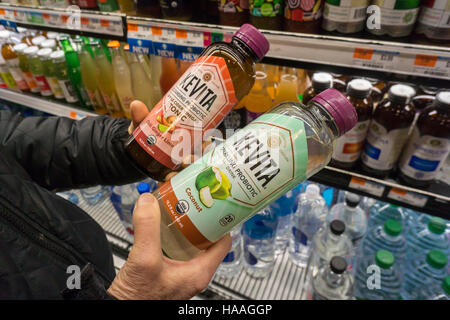 Un acquirente sceglie tra diversi sapori di marca KeVita frizzanti bevande probiotici in un supermercato raffreddatore in New York Martedì, Novembre 22, 2016. PepsiCo ha annunciato che acquisterà il probiotico KeVita produttore di bevande per un importo segrete. (© Richard B. Levine) Foto Stock