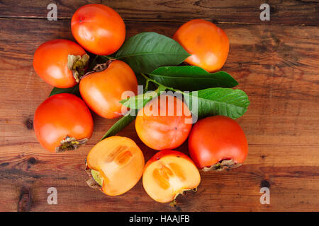 Persimmon kaki su sfondo di legno. Vista dall'alto. Foto Stock