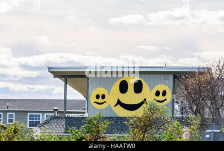 Volti felici sul lato di un edificio commerciale a Montauk NY Foto Stock