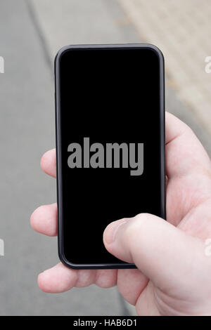 Mano azienda smartphone Foto Stock