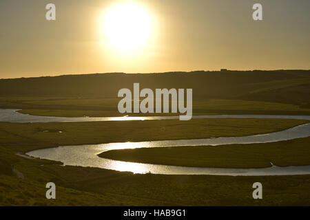 Cuckmere Haven, East Sussex. Il sole tramontare sull'iconico meandri del fiume Cuckmere nel South Downs National Park Foto Stock