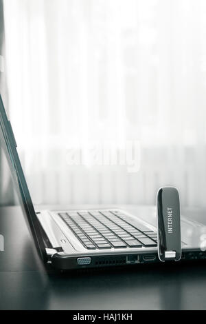 Computer portatile con connessione internet mobile sul tavolo Foto Stock