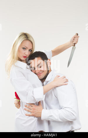 Ragazza con il coltello traditore. l uomo con rosa in mano. Foto Stock