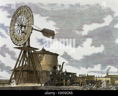 West americano. Xix secolo. Laramie, Wyoming. Union Pacific Railroad. Stazione ferroviaria con un grande serbatoio di acqua ed un mulino a vento per riempire la locomotiva. Incisione colorata, 1869. Foto Stock
