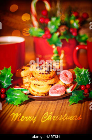 Merry Christmas greeting card, bella accogliente dolci festosa vita ancora, gustosi biscotti fatti in casa con due tazze di cioccolata calda sul tavolo di legno Foto Stock