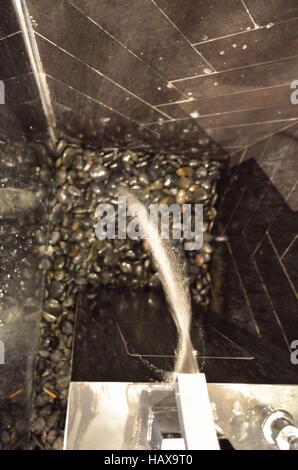 lampada a sospensione arancione con piccoli diamanti di vetro su sfondo scuro sfocato Foto Stock