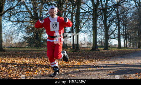 Londra, Regno Unito. Il 4 dicembre 2016. Guide di scorrimento in costumi di festa prendere parte alla Santa Dash in Cassiobury Park a Watford, raccolta di fondi per Mencap, una carità sostiene le persone con difficoltà di apprendimento e le loro famiglie. Questo evento è uno dei tanti Santa-ispirato le gare che si svolge oggi in tutta Londra la raccolta di fondi per una buona causa. Credito: Stephen Chung / Alamy Live News Foto Stock