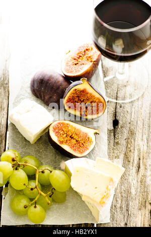 Fichi, uva, formaggio e un bicchiere di vino Foto Stock