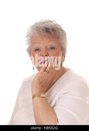 Senior donna faccia tenuta in mano. Foto Stock