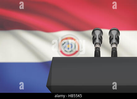 Pulpito e due microfoni con una bandiera su sfondo - Paraguay Foto Stock