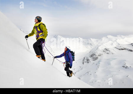 Gli alpinisti salita coperta di neve montagna, Saas Fee, Svizzera Foto Stock